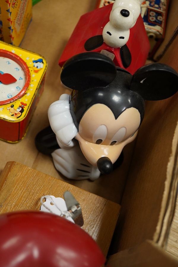 A group of thirteen novelty money boxes, including a Noddy book money box, a Snoopy money box and a Micky Mouse money box. Condition - varies